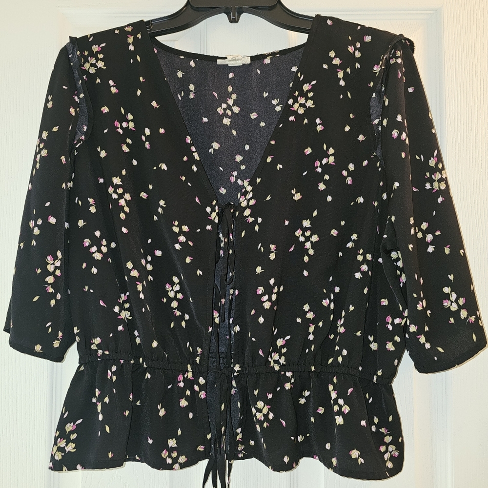 A.n.a black floral-patterned, lace-up crop top with a ruffled hem.